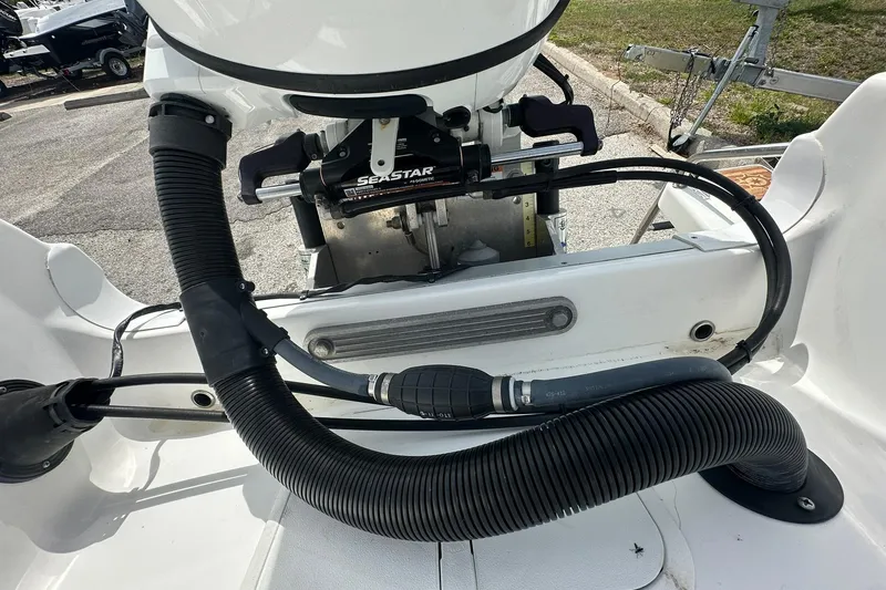 Slide: The Image of 2024 NauticStar 211 Hybrid boat engine compartment with SeaStar hydraulic steering system. - 27
