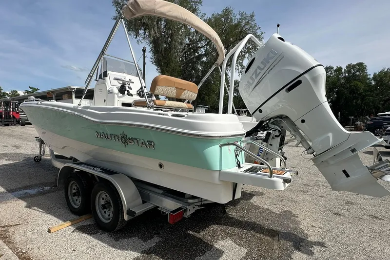 Slide: The Image of 2024 NauticStar 211 Hybrid boat with Suzuki outboard engine on trailer. - 28
