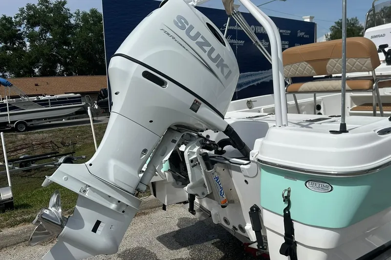Slide: The Image of 2024 NauticStar 211 Hybrid boat with Suzuki outboard motor, docked outdoors. - 30