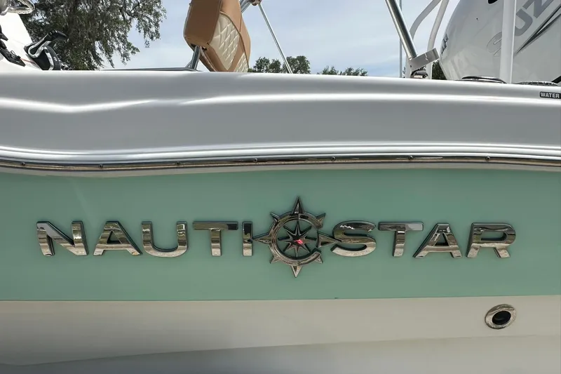 Slide: The Image of 2024 NauticStar 211 Hybrid boat logo on a light green hull. - 5