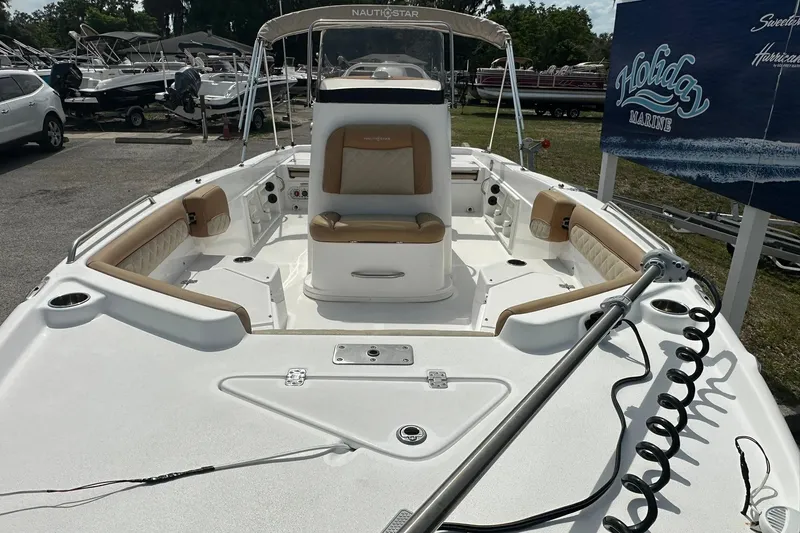 Slide: The Image of 2024 NauticStar 211 Hybrid boat with tan seating, displayed at Holiday Marine. - 7