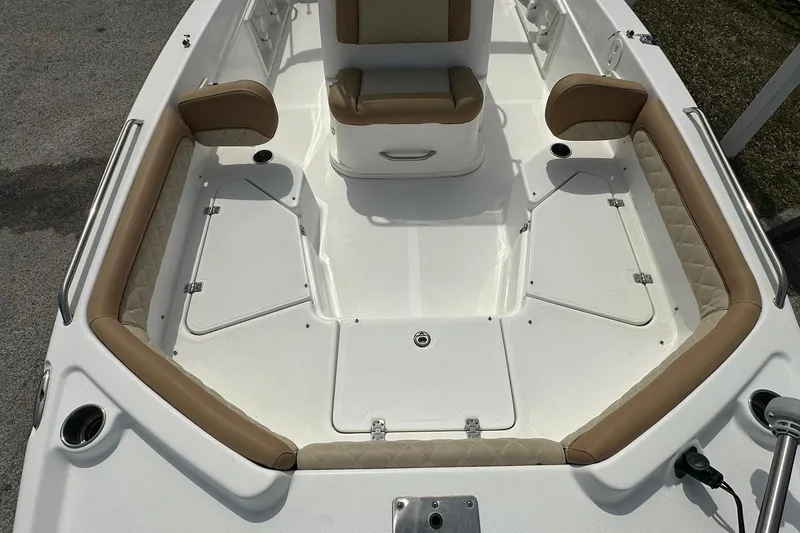 Slide: The Image of 2024 NauticStar 211 Hybrid boat interior with tan seating and white deck. - 8