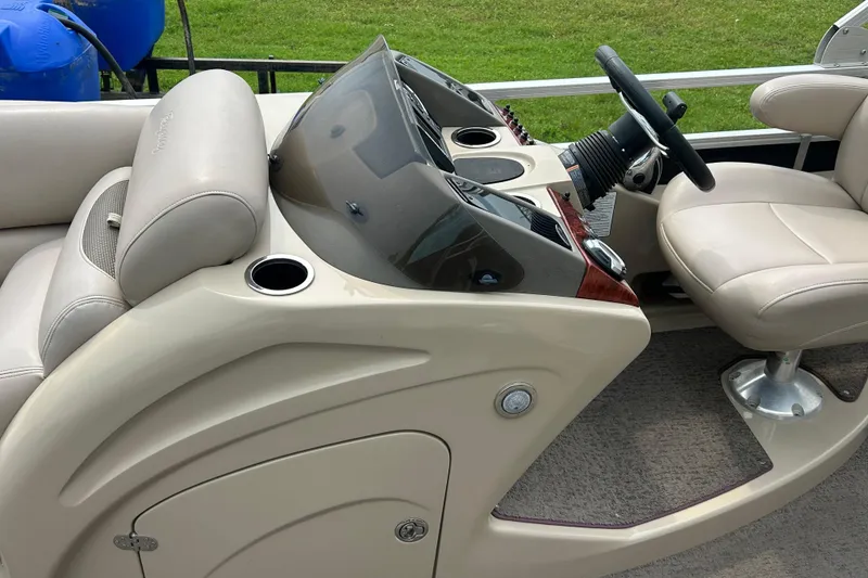Slide: The Image of 2014 Regency 220 DL3 boat interior with steering console and seating. - 13
