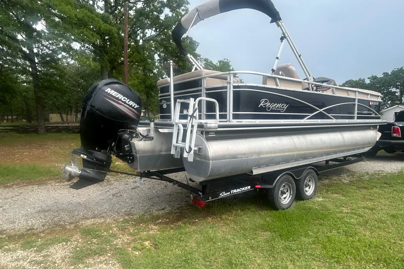Slide: The Image of 2014 Regency 220 DL3 pontoon boat with Mercury outboard engine on trailer. - 5