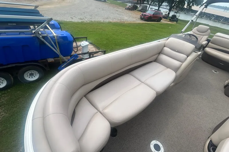 Slide: The Image of 2014 Regency 220 DL3 pontoon boat with beige seating and spacious interior. - 8