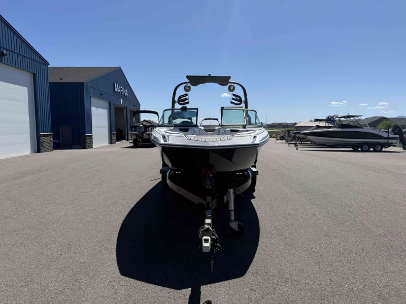 Slide: The Image of 2018 Nautique Super Air Nautique GS22 in front of a marina. - 3