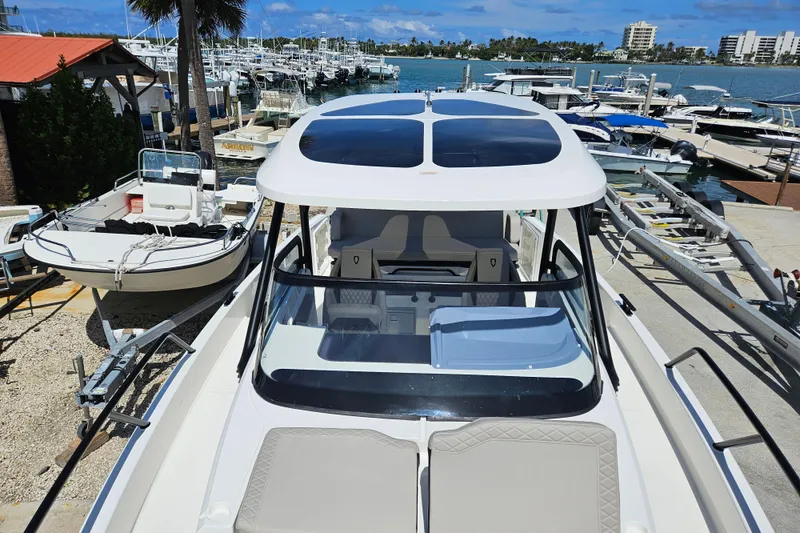 Slide: The Image of Navan S30 2026 boat docked at marina under blue sky. - 16