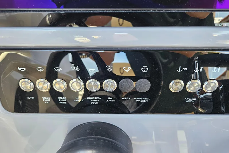 Slide: The Image of Navan S30 2026 boat control panel with various switches. - 18