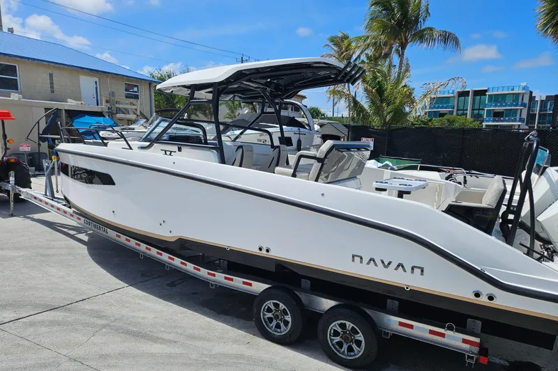 Slide: The Image of Navan S30 boat 2026 on trailer, sunny day, palm trees in background. - 3