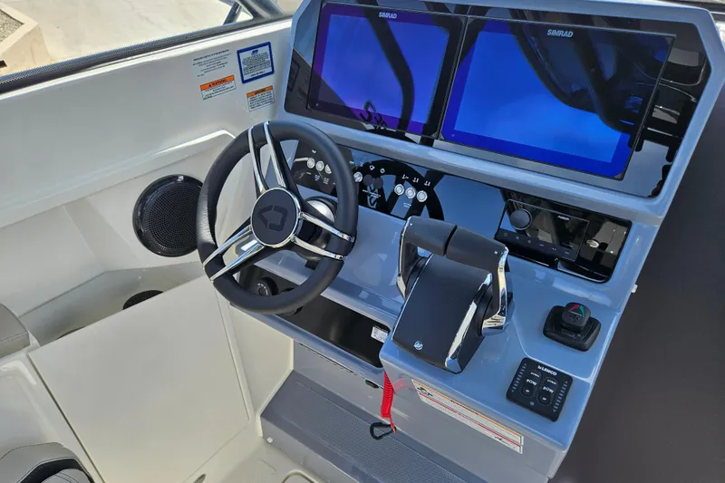 Slide: The Image of Navan S30 2026 boat console with steering wheel and Simrad screens. - 7