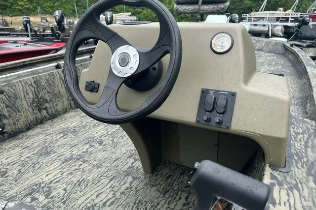 Slide: The Image of 2026 Tracker Grizzly 1754 SC boat console with steering wheel and control panel. - 4