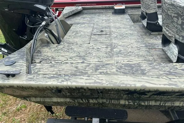 Slide: The Image of 2026 Tracker Grizzly 1754 SC boat with camouflage design and outboard motor. - 5