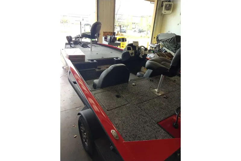 Slide: The Image of 2026 Tracker Pro Team 190 boat interior with seating and steering wheel in a garage setting. - 55