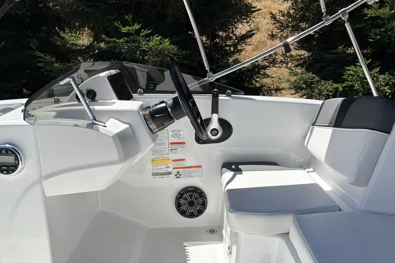 Slide: The Image of Interior of 2026 Tahoe T16 boat featuring steering wheel and seating area. - 27