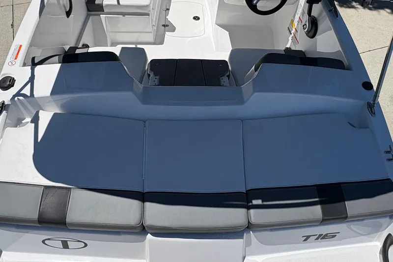 Slide: The Image of 2026 Tahoe T16 boat interior with cushioned seating and steering console. - 20