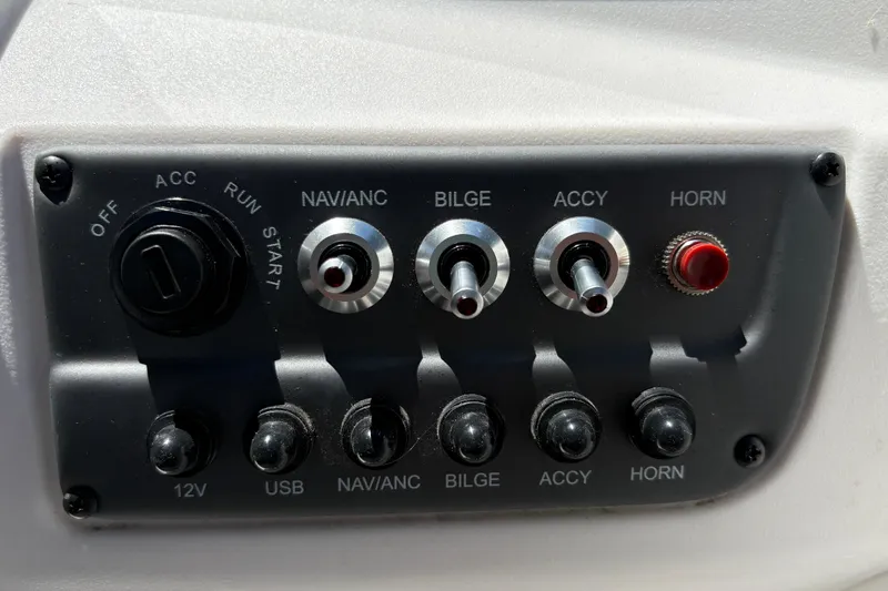 Slide: The Image of Control panel of a 2026 Tahoe T16 boat with switches and ignition. - 16