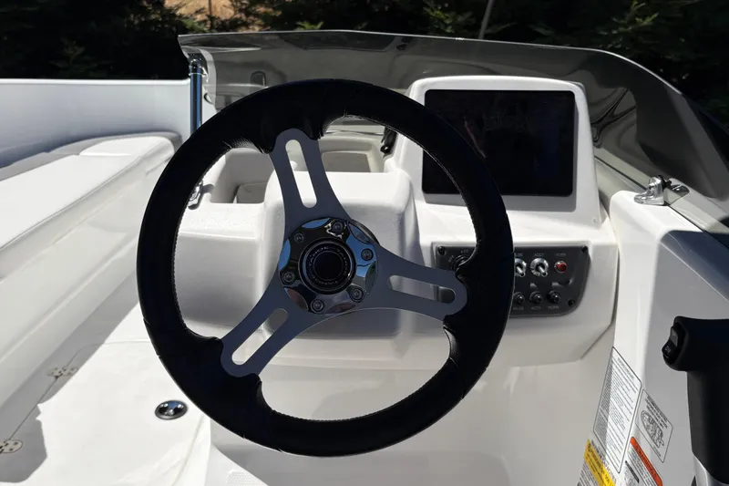 Slide: The Image of Steering wheel and dashboard of 2026 Tahoe T16 boat, featuring modern controls and sleek design. - 17