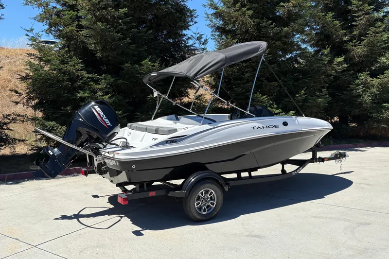 Slide: The Image of 2026 Tahoe T16 boat with Mercury engine on trailer, parked outdoors. - 4