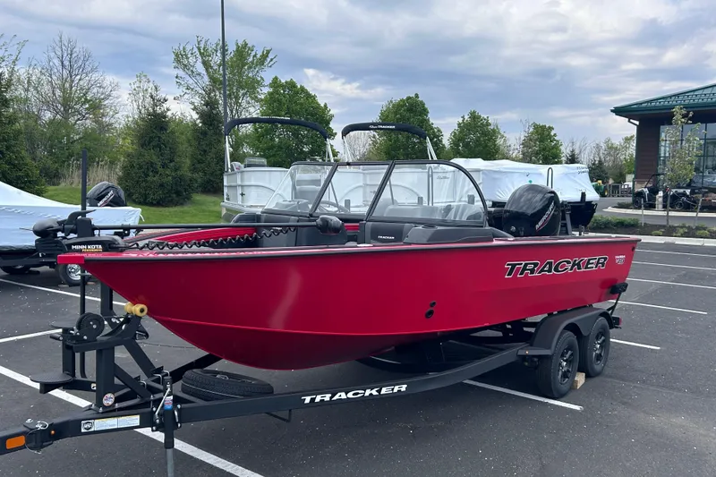 The Image of 2026 Tracker Targa V-19 Combo boat in parking lot, vibrant red color. - 0