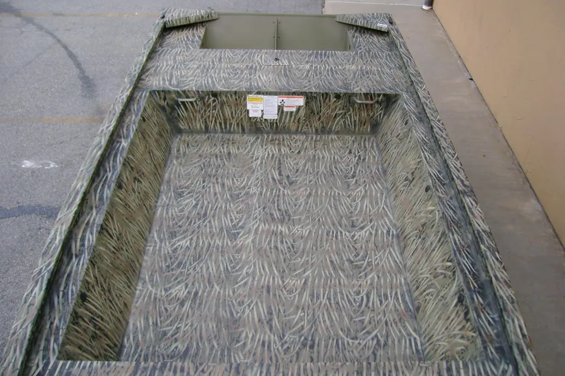 Slide: The Image of 2026 Tracker Grizzly 1648 Utility boat with camouflage interior design. - 5
