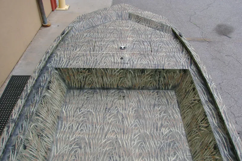 Slide: The Image of 2026 Tracker Grizzly 1648 Utility boat with camouflage interior design. - 6
