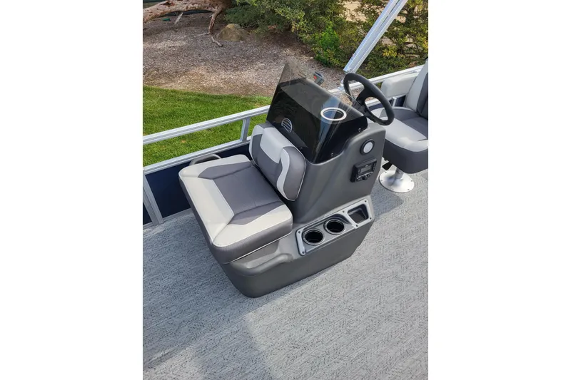 Slide: The Image of 2026 Sun Tracker Bass Buggy 16 XL Select boat console with seating and steering wheel. - 80