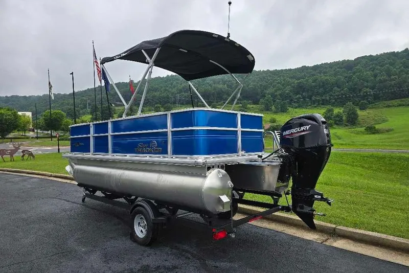 Slide: The Image of 2026 Sun Tracker Party Barge 18 DLX pontoon boat with Mercury engine on trailer. - 7