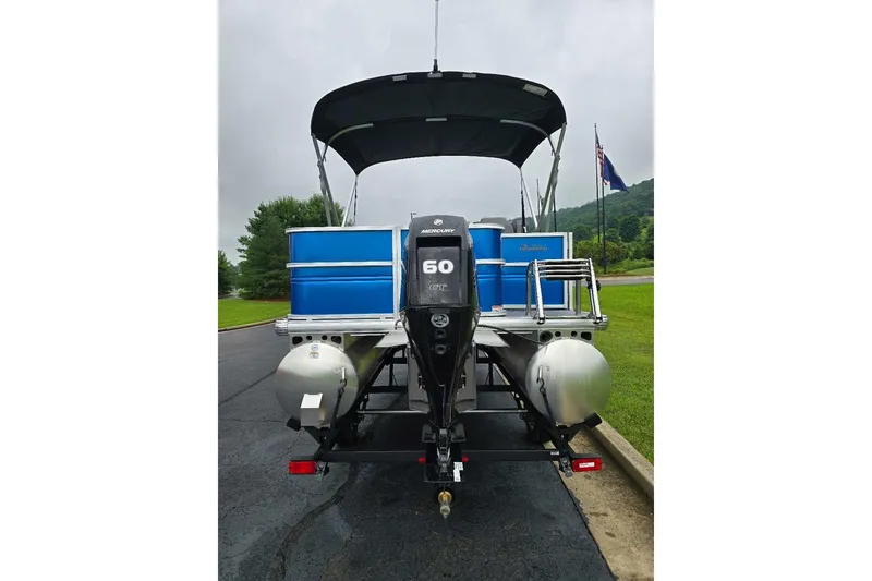 Slide: The Image of 2026 Sun Tracker Party Barge 18 DLX pontoon boat with Mercury 60 HP engine, rear view. - 6
