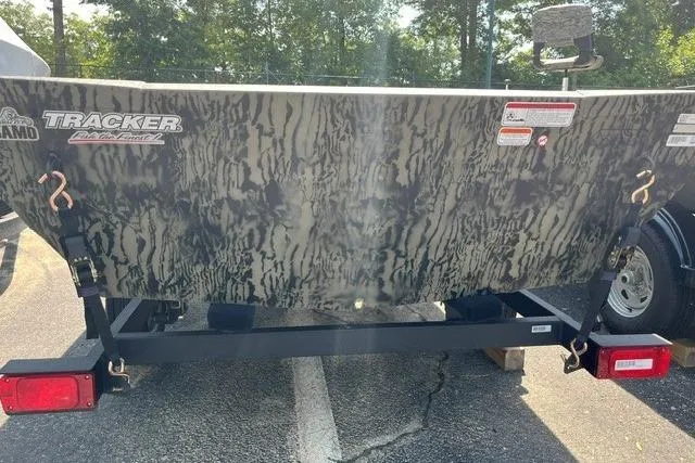 Slide: The Image of 2026 Tracker Grizzly 1648 Utility boat with camouflage design on a trailer. - 5