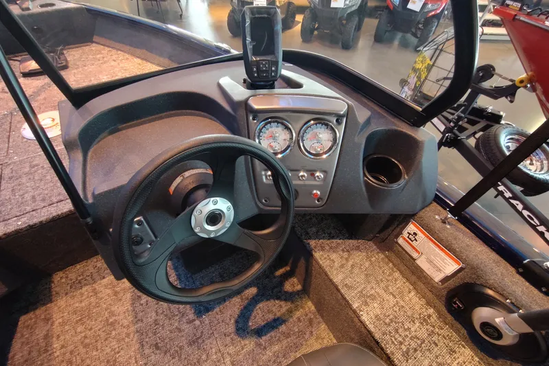 Slide: The Image of 2026 Tracker Pro Guide V-16 WT boat dashboard with steering wheel and gauges. - 3
