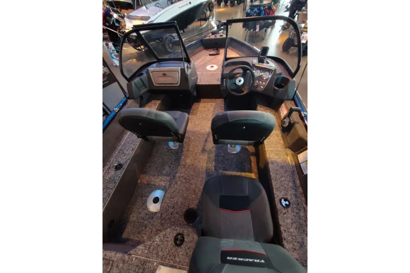 Slide: The Image of 2026 Tracker Pro Guide V-16 WT boat interior with dual seats and steering console. - 4