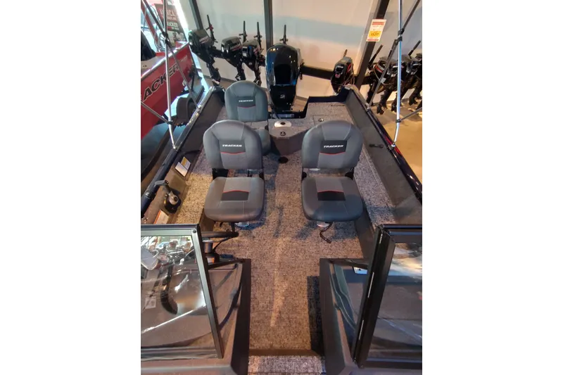 Slide: The Image of 2026 Tracker Pro Guide V-16 WT boat interior with four seats and motor display. - 2