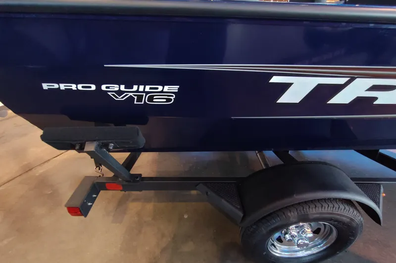 Slide: The Image of 2026 Tracker Pro Guide V-16 WT boat on trailer, showcasing sleek design and branding. - 52