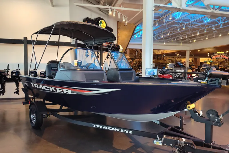 The Image of 2026 Tracker Pro Guide V-16 WT boat displayed indoors on a trailer. - 0