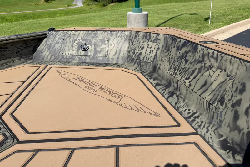 Slide: The Image of 2026 Tracker Grizzly 1650 T Prairie Wings Edition boat interior with camouflage design. - 14