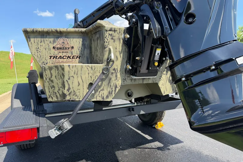 Slide: The Image of 2026 Tracker Grizzly 1650 T Prairie Wings Edition boat with camouflage design and motor detail. - 10