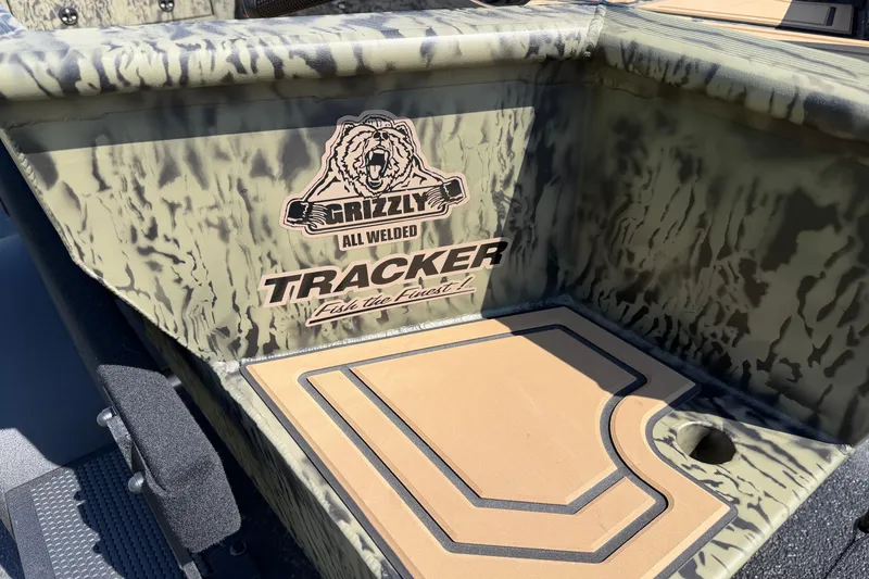 Slide: The Image of 2026 Tracker Grizzly 1650 T Prairie Wings Edition boat with camouflage design and logo. - 11