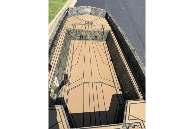 Slide: The Image of 2026 Tracker Grizzly 1650 T Prairie Wings Edition boat interior with camouflage design. - 17