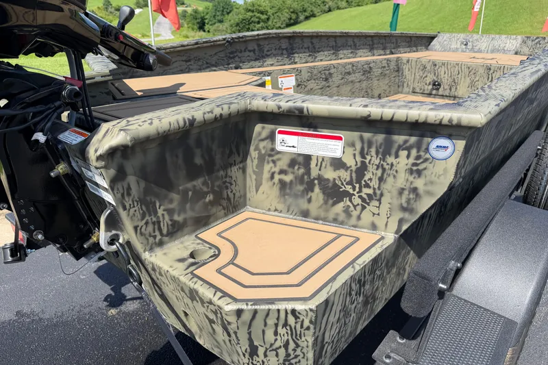 Slide: The Image of 2026 Tracker Grizzly 1650 T Prairie Wings Edition boat with camouflage design and motor detail. - 12