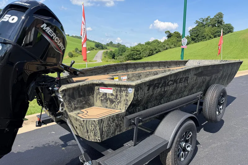 Slide: The Image of 2026 Tracker Grizzly 1650 T Prairie Wings Edition boat with Mercury engine on trailer. - 4