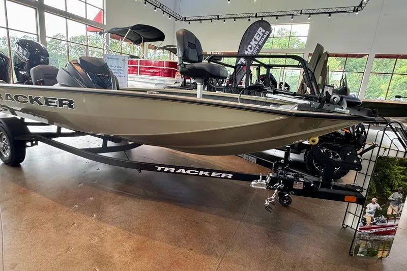 The Image of A 2026 Tracker Pro Team 175 Crappie Edition boat on a trailer in a showroom. - 0