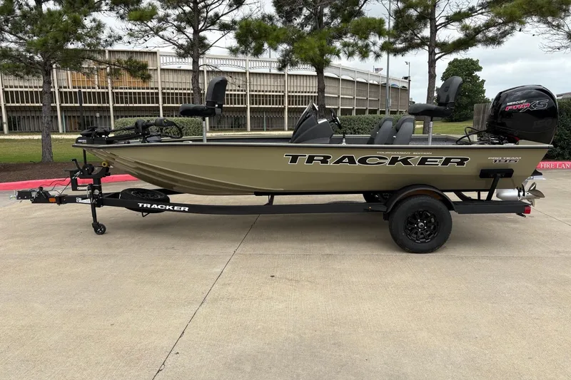 The Image of 2026 Tracker Pro Team 195 boat on trailer, parked outdoors. - 0