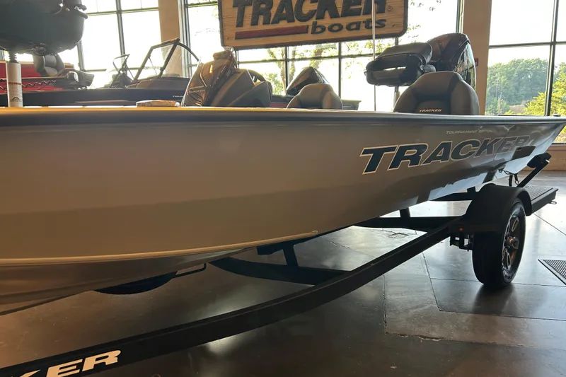 Slide: The Image of 2026 Tracker Pro Team 190 boat displayed indoors with visible branding and trailer. - 2