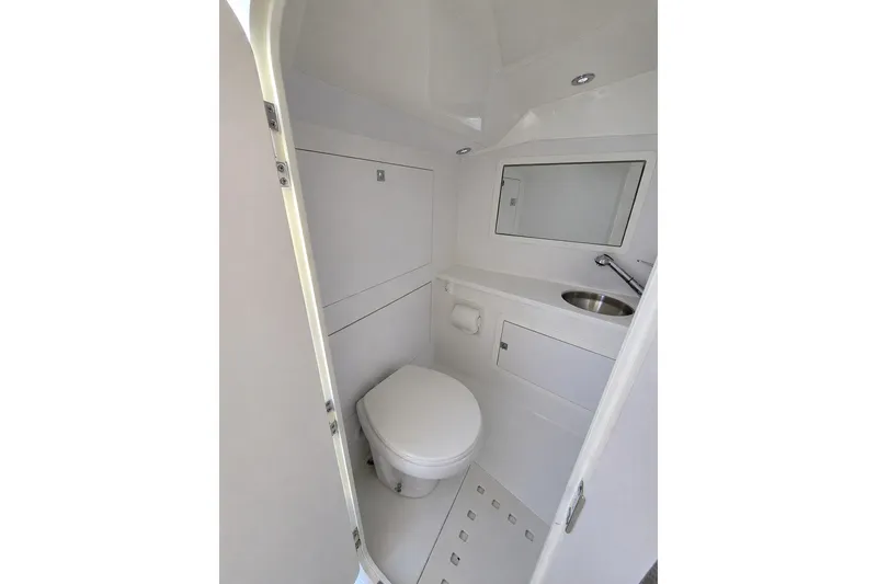 Slide: The Image of Compact bathroom in 2016 VanDutch 40 yacht, featuring toilet, sink, and mirror. - 11