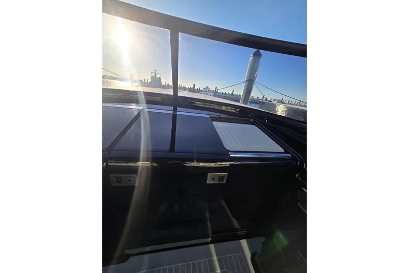 Slide: The Image of 2016 VanDutch 40 yacht interior with city skyline and sunlight reflections. - 7