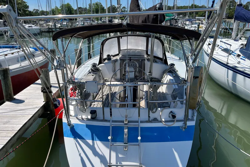 The Image of 1986 Wauquiez Petorine sailboat docked at marina, rear view with equipment visible. - 0
