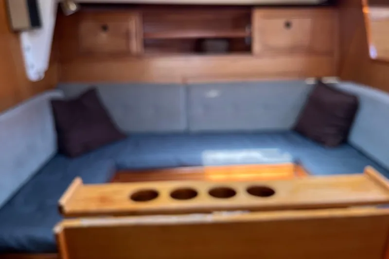 Slide: The Image of Interior of 1986 Wauquiez Petorine yacht with wooden furnishings and cushioned seating. - 12