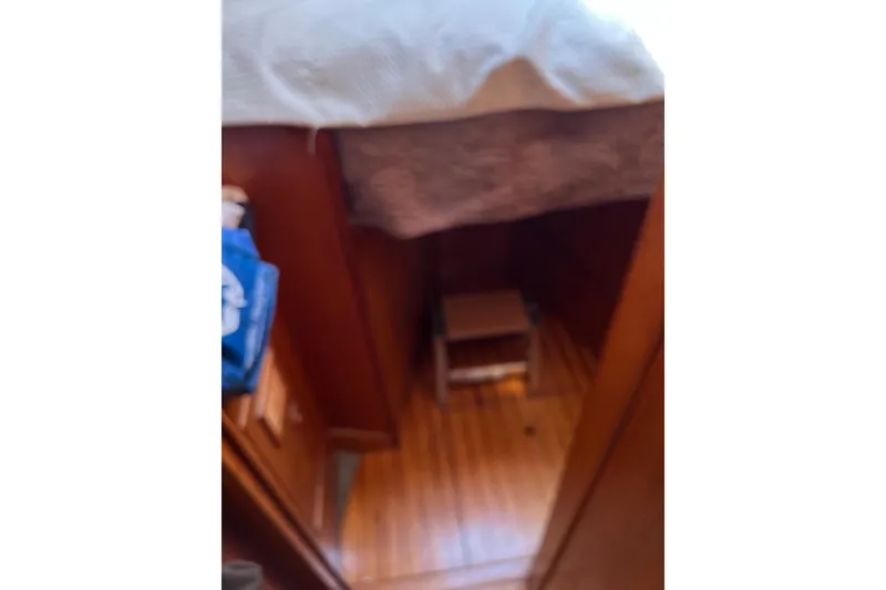 Slide: The Image of Interior of 1986 Wauquiez Petorine sailboat with wooden flooring and cozy cabin space. - 20