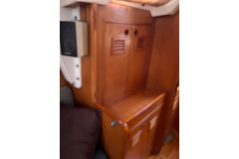 Slide: The Image of Interior of 1986 Wauquiez Petorine sailboat with wooden cabinetry and speaker. - 22