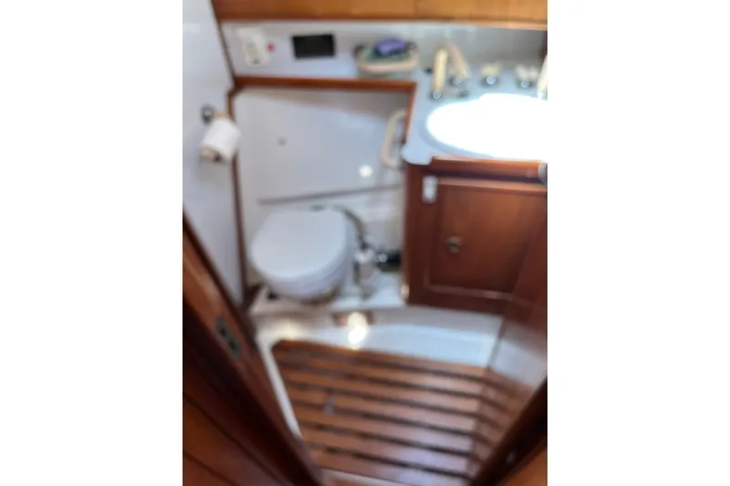 Slide: The Image of 1986 Wauquiez Petorine yacht bathroom with wooden accents and compact design. - 23